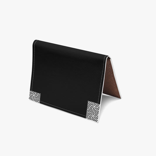 Black leather cardholder with geometric pattern on a white background
