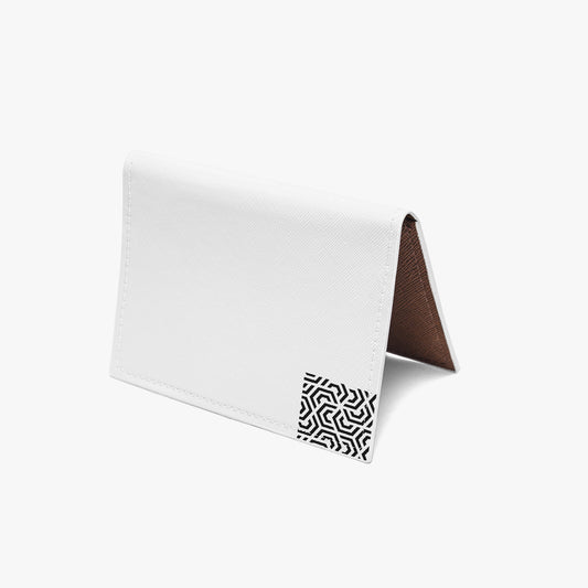 White card with a brown corner and black geometric pattern on a white background
