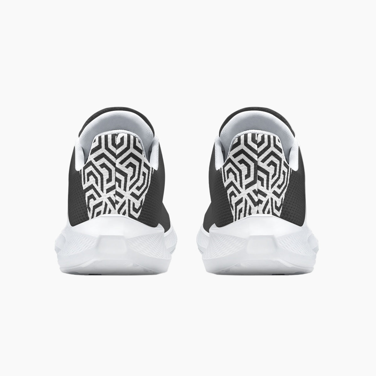 Black and white slip-on shoes with geometric pattern on a white background