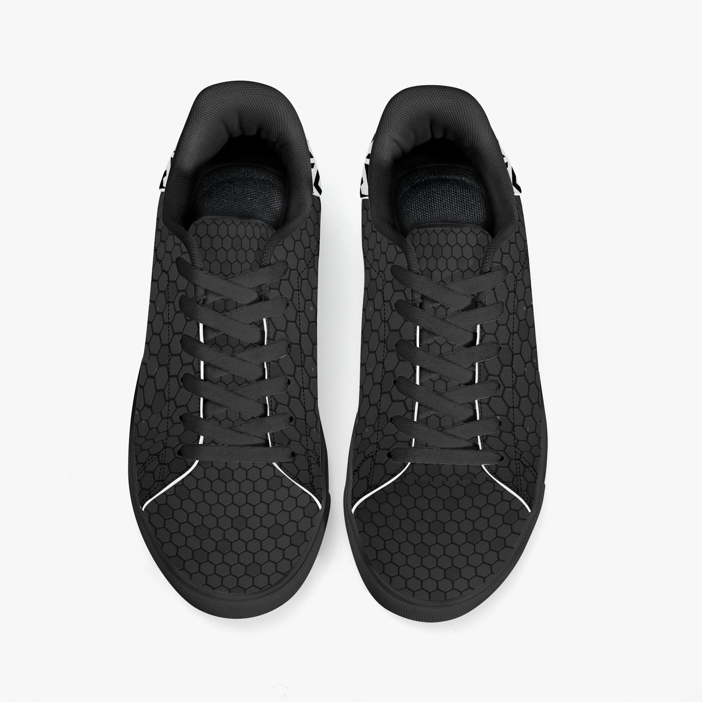 Black sneakers with a textured pattern on a white background