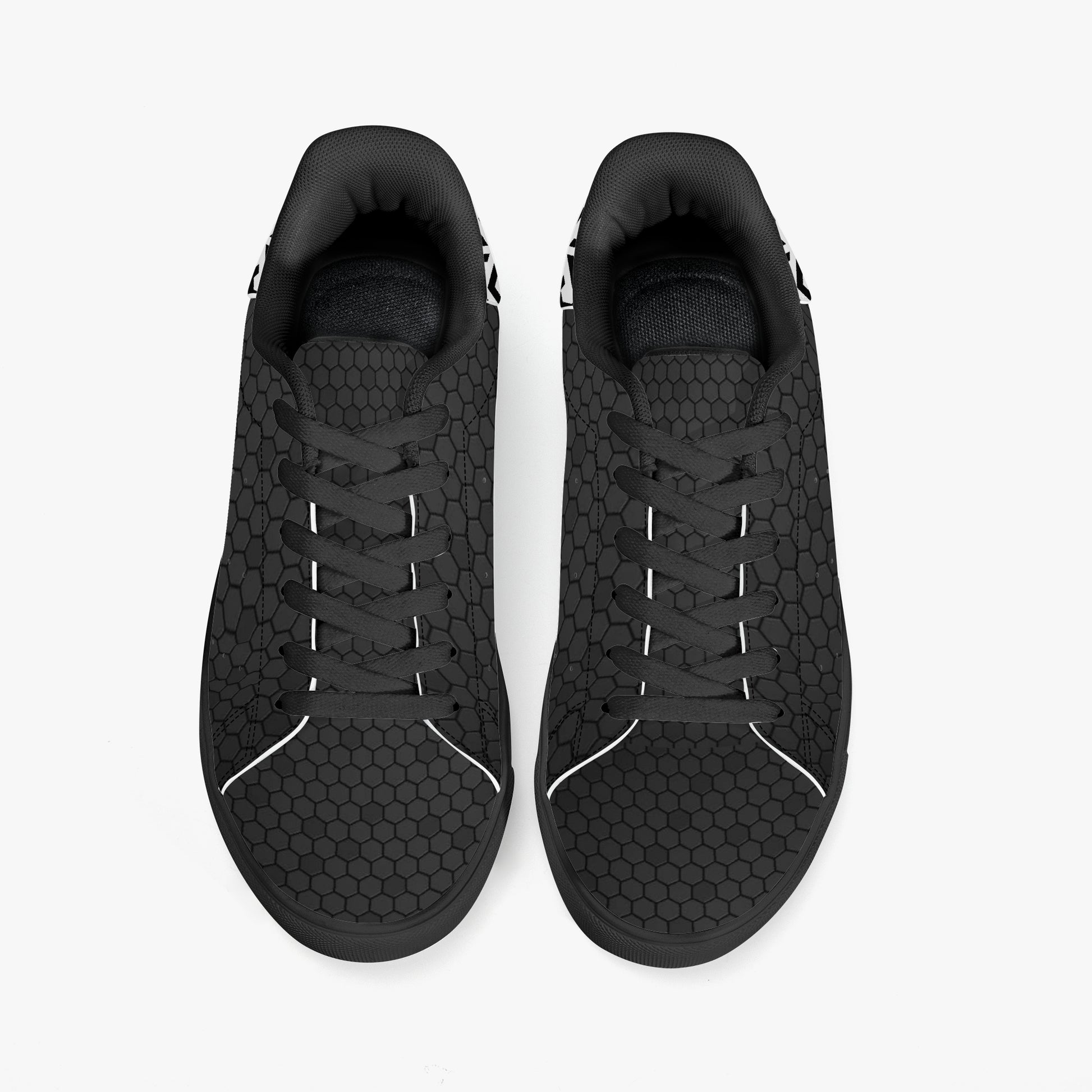 Black sneakers with a textured pattern on a white background