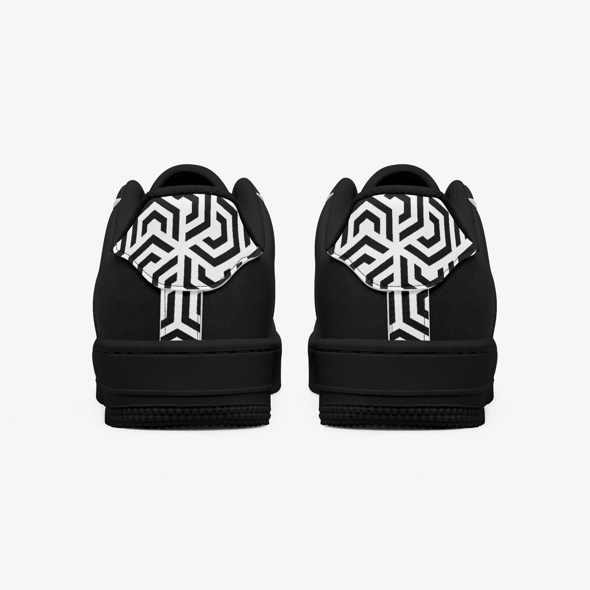 Black shoes with white geometric patterns on a white background