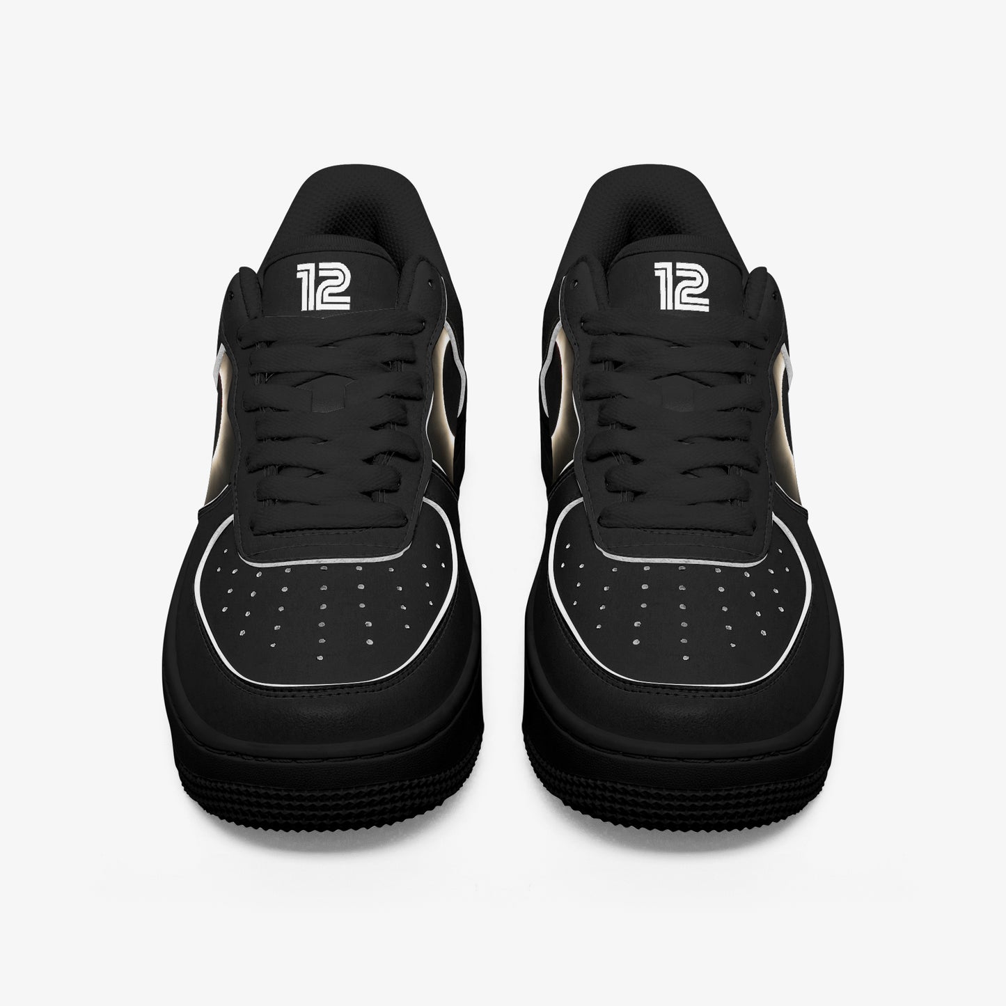 Black sneakers with white accents on a light gray background