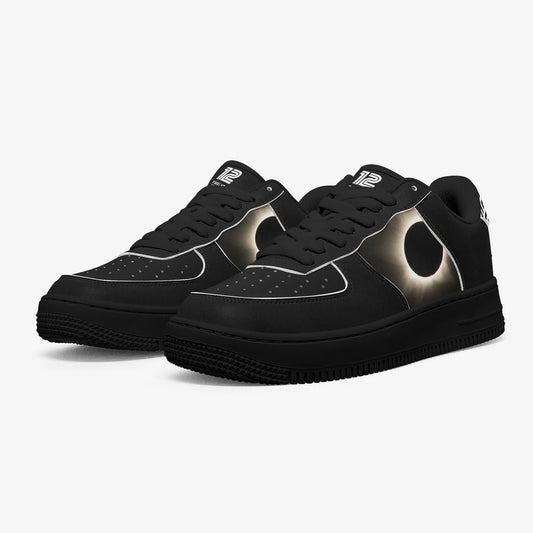 Black sneakers with a metallic design on a white background