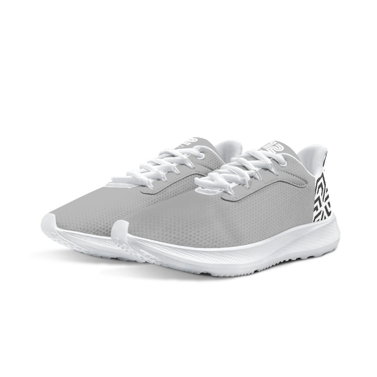 Gray athletic shoes with white laces on a white background