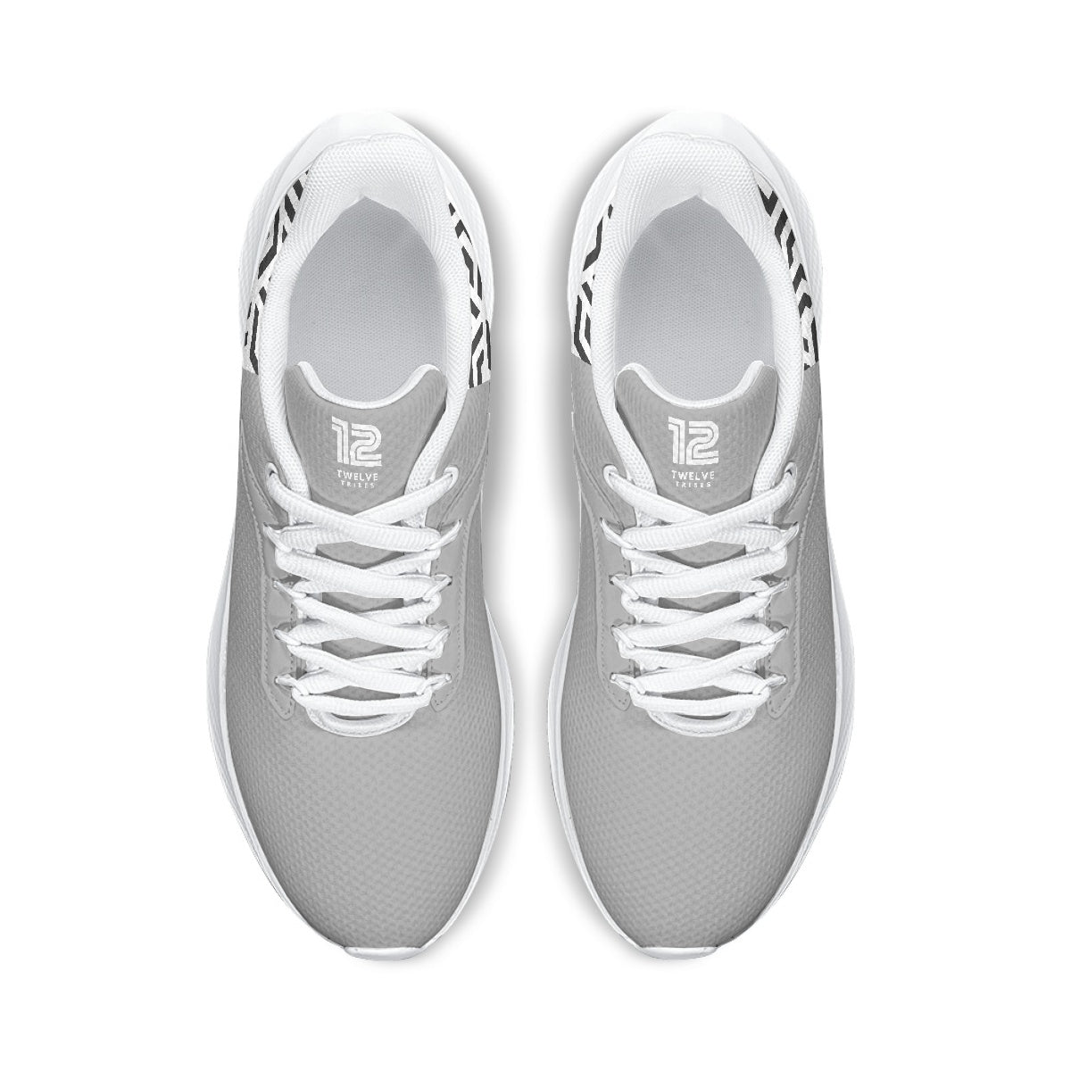 Pair of gray sneakers with white laces on a white background