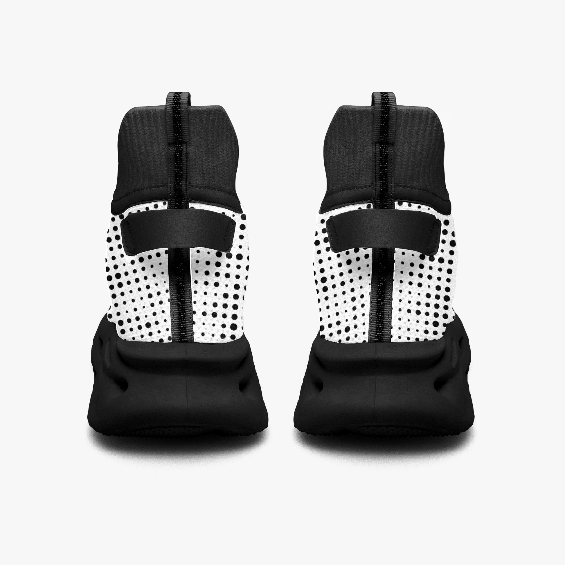 Pair of black and white polka dot shoes on a light gray background