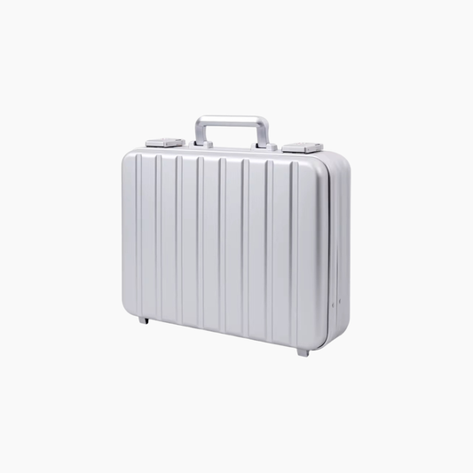 Silver aluminum suitcase with a ribbed texture on a white background