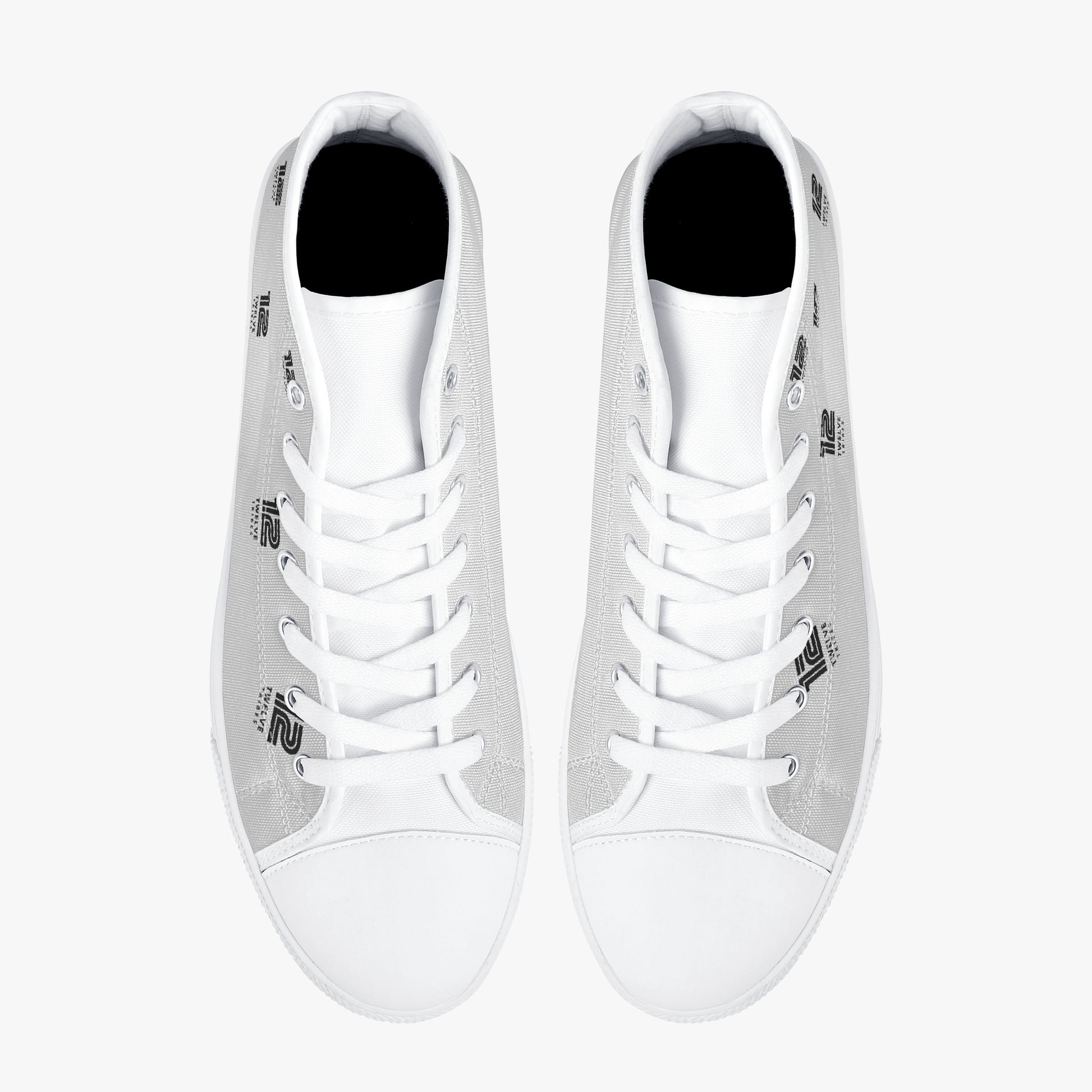 Pair of white high-top sneakers on a white background